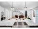 Bright modern kitchen with large island, stainless steel sink and fixtures, and pendant lighting at 15818 Sparrowridge Ct, Charlotte, NC 28278