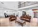 Open-concept living room with hardwood floors, modern furnishings, and a view of the kitchen at 15818 Sparrowridge Ct, Charlotte, NC 28278