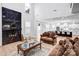 Chic living area featuring a marble fireplace, hardwood floors, modern furniture, and views of the kitchen at 15818 Sparrowridge Ct, Charlotte, NC 28278