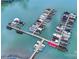 Aerial view of marina with multiple docks, boat slips, and various boats on calm water at 15818 Sparrowridge Ct, Charlotte, NC 28278