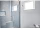 Modern shower design featuring light blue subway tiles, a glass door and chrome fixtures at 15818 Sparrowridge Ct, Charlotte, NC 28278