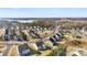 Aerial view of a home in a neighborhood with a lake in the distance at 16617 Cozy Cove Rd, Charlotte, NC 28278