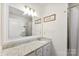 Well-lit bathroom featuring granite countertops, and a large mirror above the vanity at 16617 Cozy Cove Rd, Charlotte, NC 28278