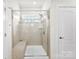 Modern bathroom featuring a glass-enclosed shower with a built-in bench and a tiled surround at 16617 Cozy Cove Rd, Charlotte, NC 28278