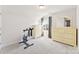 Bedroom with a stationary bike, window with shade, and large dresser at 16617 Cozy Cove Rd, Charlotte, NC 28278