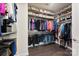 Walk-in closet with wood floor, including custom shelving and hanging rods for optimal storage at 16617 Cozy Cove Rd, Charlotte, NC 28278