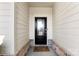 Close-up of the inviting front door with decorative glass, framed by a brick facade at 16617 Cozy Cove Rd, Charlotte, NC 28278