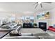 Cozy living room features a fireplace, large windows, and comfortable seating at 16617 Cozy Cove Rd, Charlotte, NC 28278