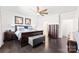 Main bedroom featuring a ceiling fan, dark wood floors, and ample natural light at 16617 Cozy Cove Rd, Charlotte, NC 28278