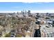 Expansive aerial view capturing the city skyline and residential neighborhood below on a sunny day at 1714 S Tryon St, Charlotte, NC 28203