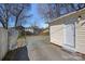 View of the backyard and garage, featuring a gravel ground, access door, and fenced boundaries at 1714 S Tryon St, Charlotte, NC 28203