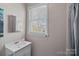 Clean bathroom featuring a vanity with sink and mirror, complemented by natural light from the window at 1714 S Tryon St, Charlotte, NC 28203