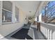 Inviting covered front porch with a cozy seating area and a view of the neighborhood at 1714 S Tryon St, Charlotte, NC 28203