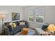 Inviting living room with neutral tones, a comfortable sofa, and windows providing natural light at 1714 S Tryon St, Charlotte, NC 28203