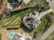 Overhead view of the home featuring a spacious backyard, deck, solar panels, and a manicured lawn at 182 Walking Horse Trl, Davidson, NC 28036