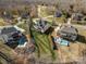 Aerial view of a neighborhood showcasing homes with spacious backyards, pools, and well-maintained lawns at 182 Walking Horse Trl, Davidson, NC 28036