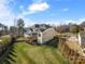 Exterior of home with a deck, screened in porch and a well maintained backyard and landscaping at 182 Walking Horse Trl, Davidson, NC 28036