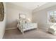 Cozy bedroom with a metal bed frame, plush carpeting, and soft, neutral colors at 182 Walking Horse Trl, Davidson, NC 28036