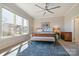 Sun-filled primary bedroom suite featuring a large window, ceiling fan, and elegant furnishings at 182 Walking Horse Trl, Davidson, NC 28036