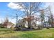 Charming brick and siding home with a well-manicured lawn, mature trees, and a stone-lined garden at 182 Walking Horse Trl, Davidson, NC 28036