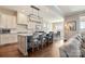 Modern kitchen featuring a large island with seating, pendant lighting, and seamless access to the adjacent dining area at 182 Walking Horse Trl, Davidson, NC 28036