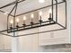 Modern kitchen features an industrial-style chandelier over white cabinets and a sleek backsplash at 182 Walking Horse Trl, Davidson, NC 28036
