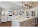 Gourmet kitchen island with granite countertops and stainless steel appliances, open to the living room with a fireplace at 182 Walking Horse Trl, Davidson, NC 28036