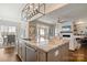 Spacious kitchen island with bar seating, modern pendant lighting, and stainless steel appliances, perfect for entertaining at 182 Walking Horse Trl, Davidson, NC 28036