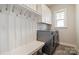 Well-organized laundry room with ample storage, a bench, and modern washer and dryer for added convenience at 182 Walking Horse Trl, Davidson, NC 28036