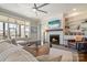 Bright and airy living room with a fireplace, custom built-ins, and large windows at 182 Walking Horse Trl, Davidson, NC 28036