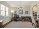 Bright and inviting office space with wainscoting, large windows, and stylish chandelier, perfect for remote work at 182 Walking Horse Trl, Davidson, NC 28036