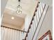 View of the staircase with a decorative light fixture and contrasting railing design at 182 Walking Horse Trl, Davidson, NC 28036