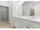 Bright bathroom showcasing a double vanity, tiled flooring, and a glass-enclosed shower at 2020 Canova Dr, Mount Holly, NC 28210