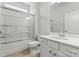 Bright bathroom featuring a shower with glass doors, white vanity, and neutral tile flooring at 2020 Canova Dr, Mount Holly, NC 28210