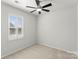 This bedroom features one window with white shutters and neutral carpet at 2020 Canova Dr, Mount Holly, NC 28210