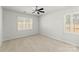 This bedroom features two windows with white shutters and neutral carpet at 2020 Canova Dr, Mount Holly, NC 28210