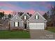 Beautiful single-Gathering home with stone and siding exterior, manicured lawn, and two-car garage at 2020 Canova Dr, Mount Holly, NC 28210