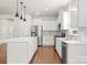 Modern kitchen with stainless steel appliances, white cabinetry, and a center island at 2020 Canova Dr, Mount Holly, NC 28210