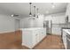Bright kitchen features a center island with pendant lighting, stainless steel appliances, and ample cabinet space at 2020 Canova Dr, Mount Holly, NC 28210