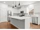Bright kitchen with stainless steel appliances, a large island, and white cabinetry at 2020 Canova Dr, Mount Holly, NC 28210