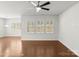 Bright living room with hardwood flooring, plantation shutters, ceiling fan, and plenty of natural light at 2020 Canova Dr, Mount Holly, NC 28210