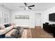 Staged living room area is furnished with area rug, sectional couch, console, and TV at 2020 Canova Dr, Mount Holly, NC 28210