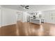 Open floor plan featuring hardwood floors, white walls and trim, stainless steel appliances, and kitchen island at 2020 Canova Dr, Mount Holly, NC 28210