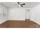 Spacious living room with hardwood flooring, ceiling fan, and natural light at 2020 Canova Dr, Mount Holly, NC 28210