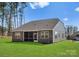 Rear exterior featuring a well maintained lawn, screened in porch and gray siding at 2020 Canova Dr, Mount Holly, NC 28210