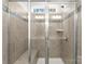 Shower stall featuring gray tile, a built-in bench, and a sliding glass door at 2020 Canova Dr, Mount Holly, NC 28210
