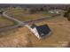 Aerial view of the home showing the expansive lawn surrounded by trees and a nearby roadway at 2095 Tite Rd, Stanfield, NC 28163