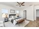 Bright bedroom featuring a ceiling fan, hardwood flooring, and a well-lit interior with large windows at 2095 Tite Rd, Stanfield, NC 28163