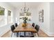 Bright dining room with a modern chandelier, wooden table, black chairs, and lots of natural light at 2095 Tite Rd, Stanfield, NC 28163
