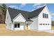 Charming exterior features white siding, black trim, a covered porch, and an attached garage at 2095 Tite Rd, Stanfield, NC 28163